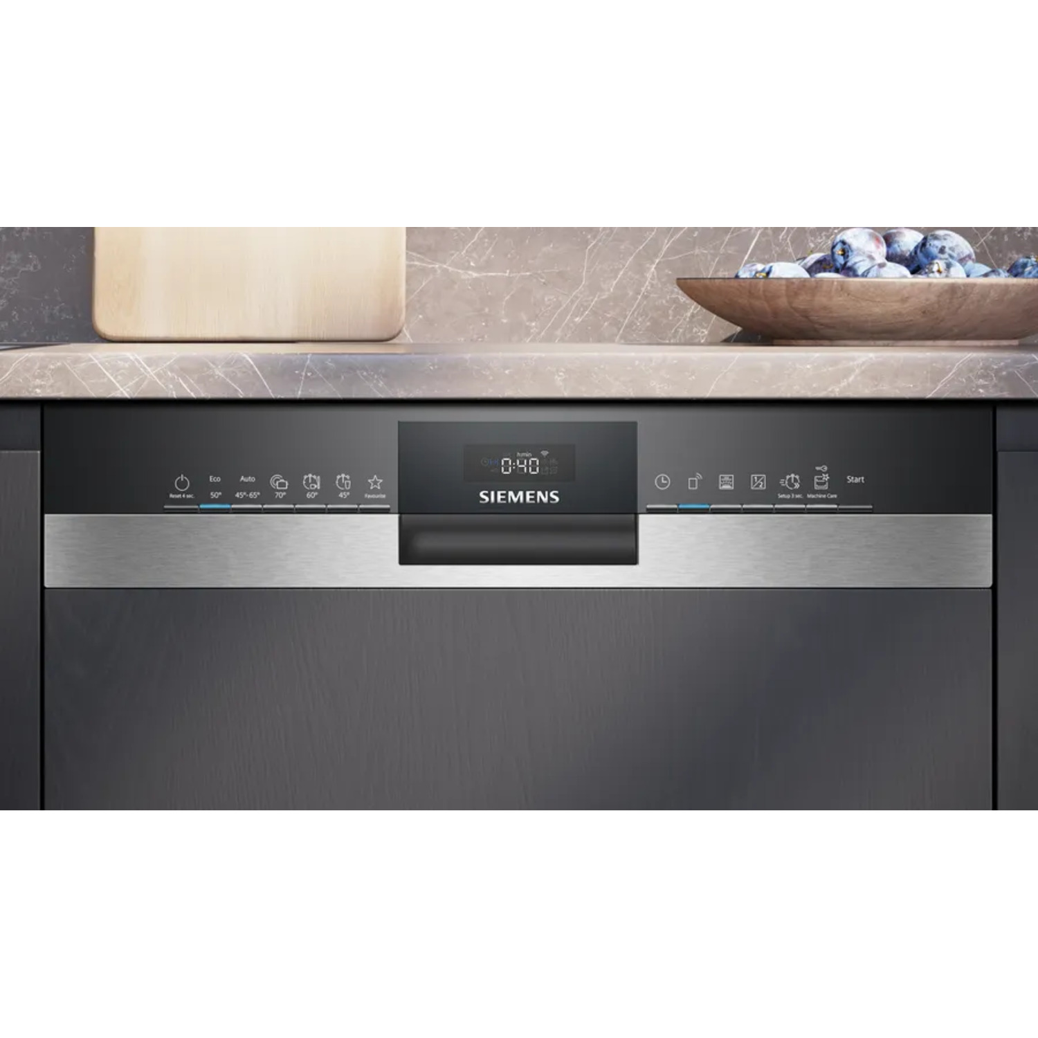Close-up of Siemens dishwasher control panel. Silver panel with display and buttons. Dark cabinets background.
