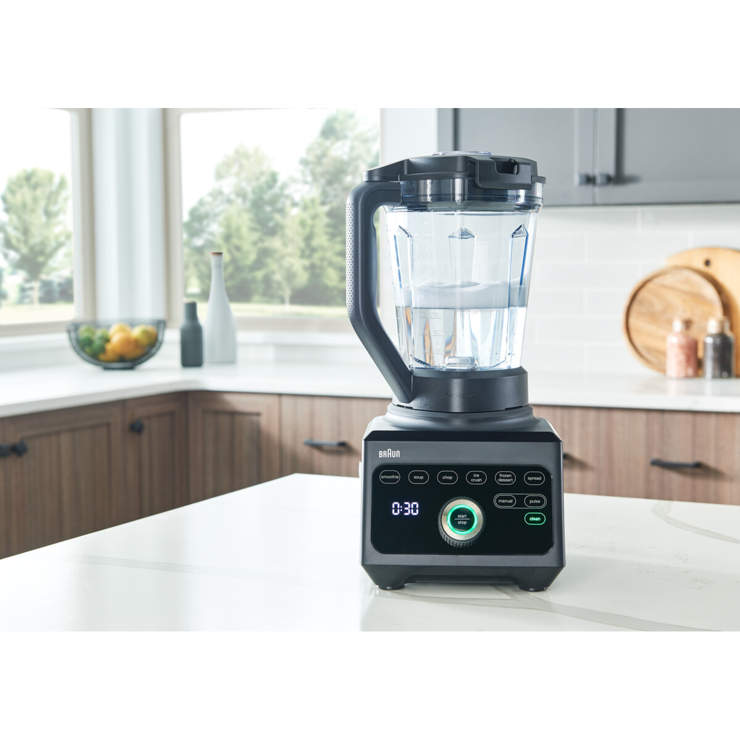 Blender is on a kitchen counter with water.