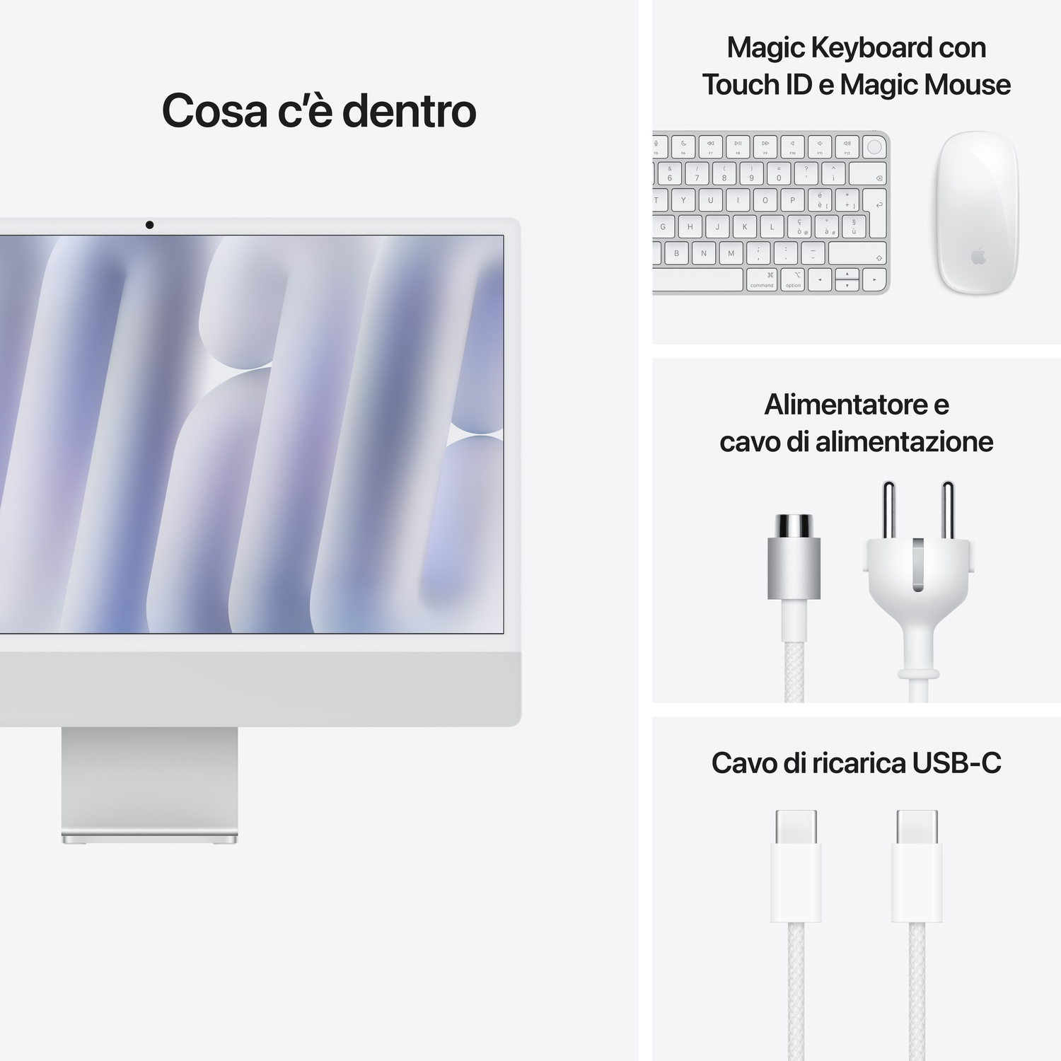 Display iMac bianco con tastiera, mouse e cavi di ricarica. La scena è interna, ben illuminata.