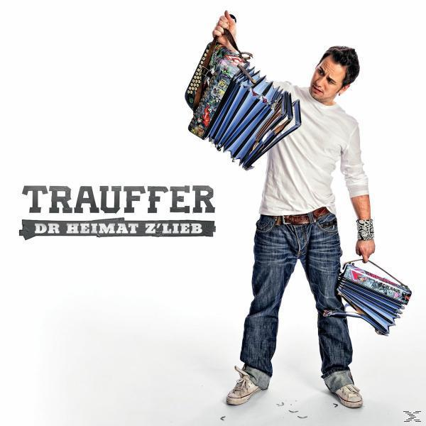 Albumcover mit einem Mann, der zwei Akkordeons hält. Der Titel lautet 'Trauffer Dr Heimat Z'Lieb'. Weißer Hintergrund.