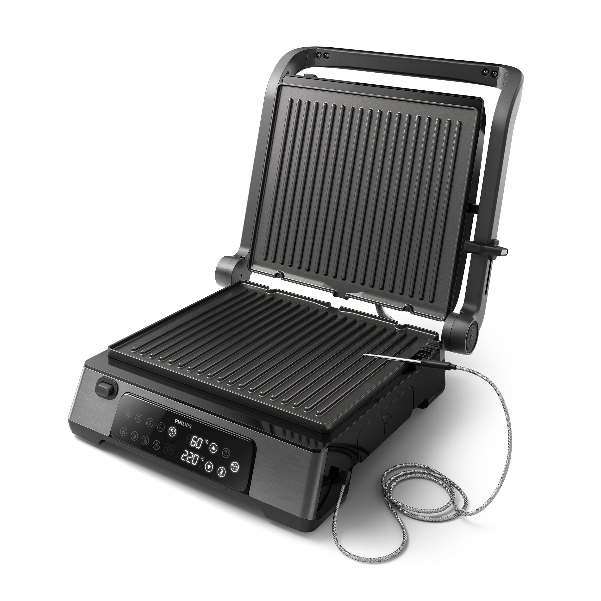 Geöffneter schwarzer Grill mit Digitalanzeige und Temperatursonde. Es ist auf weißem Hintergrund.