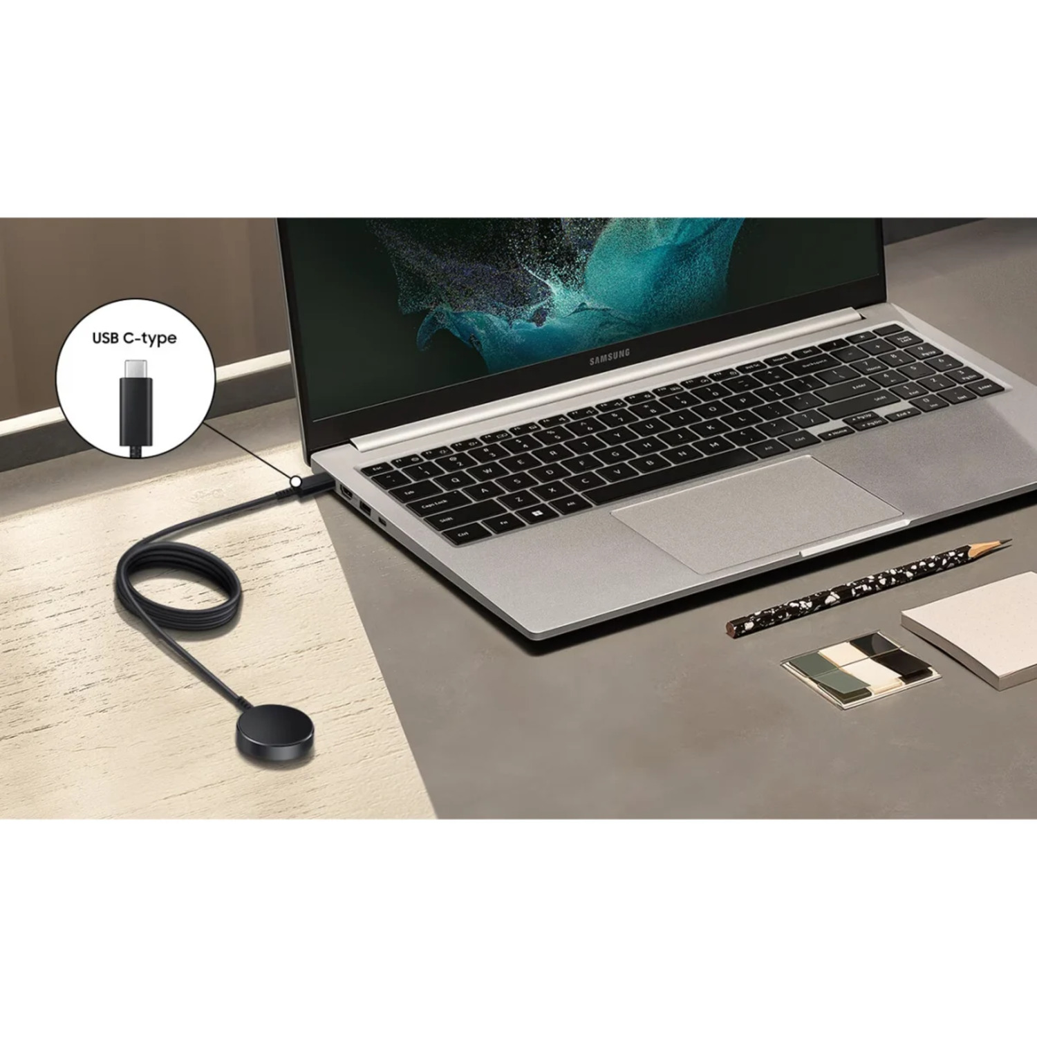 Laptop connected to a black charging dock via USB-C cable.