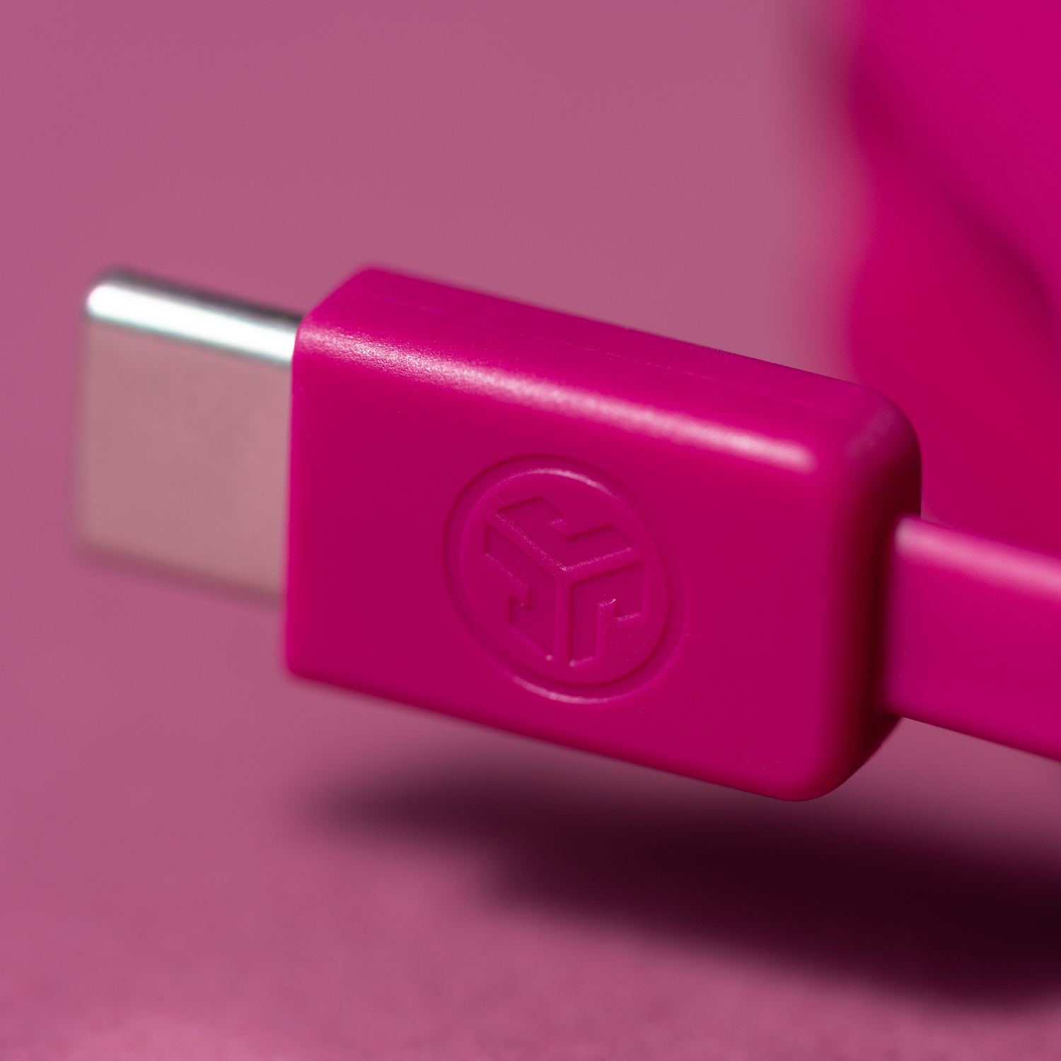 Close-up of a pink USB-C connector with a logo.