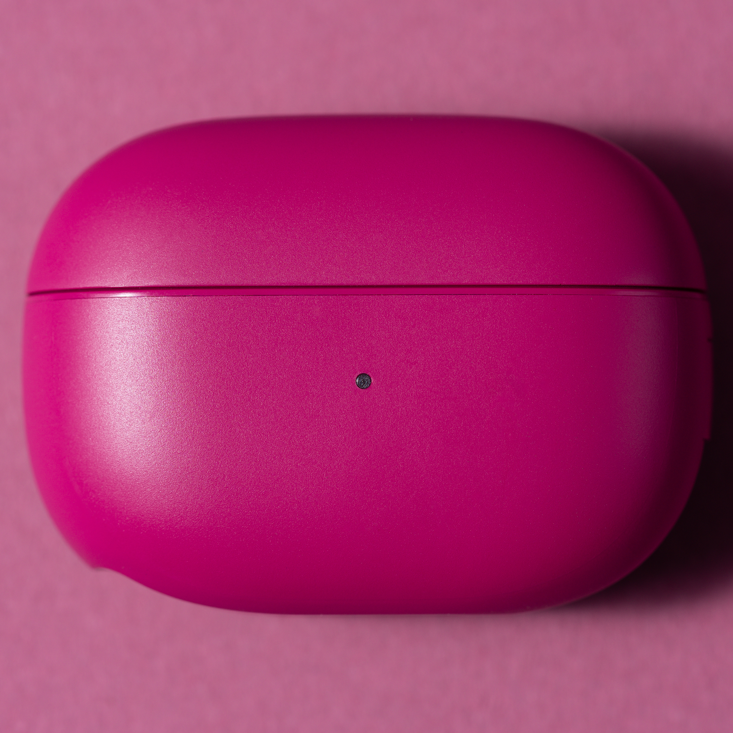 Closed pink earbuds case.