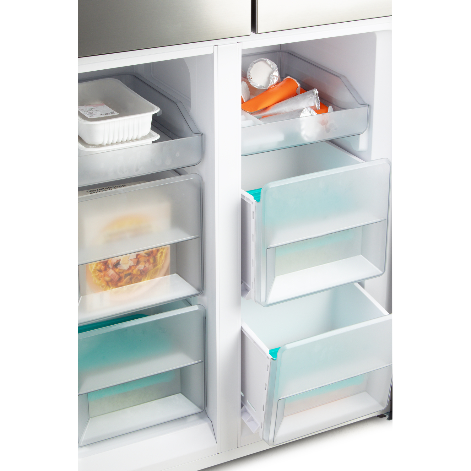 Inside of the refrigerator, showing drawers and contents with food items.