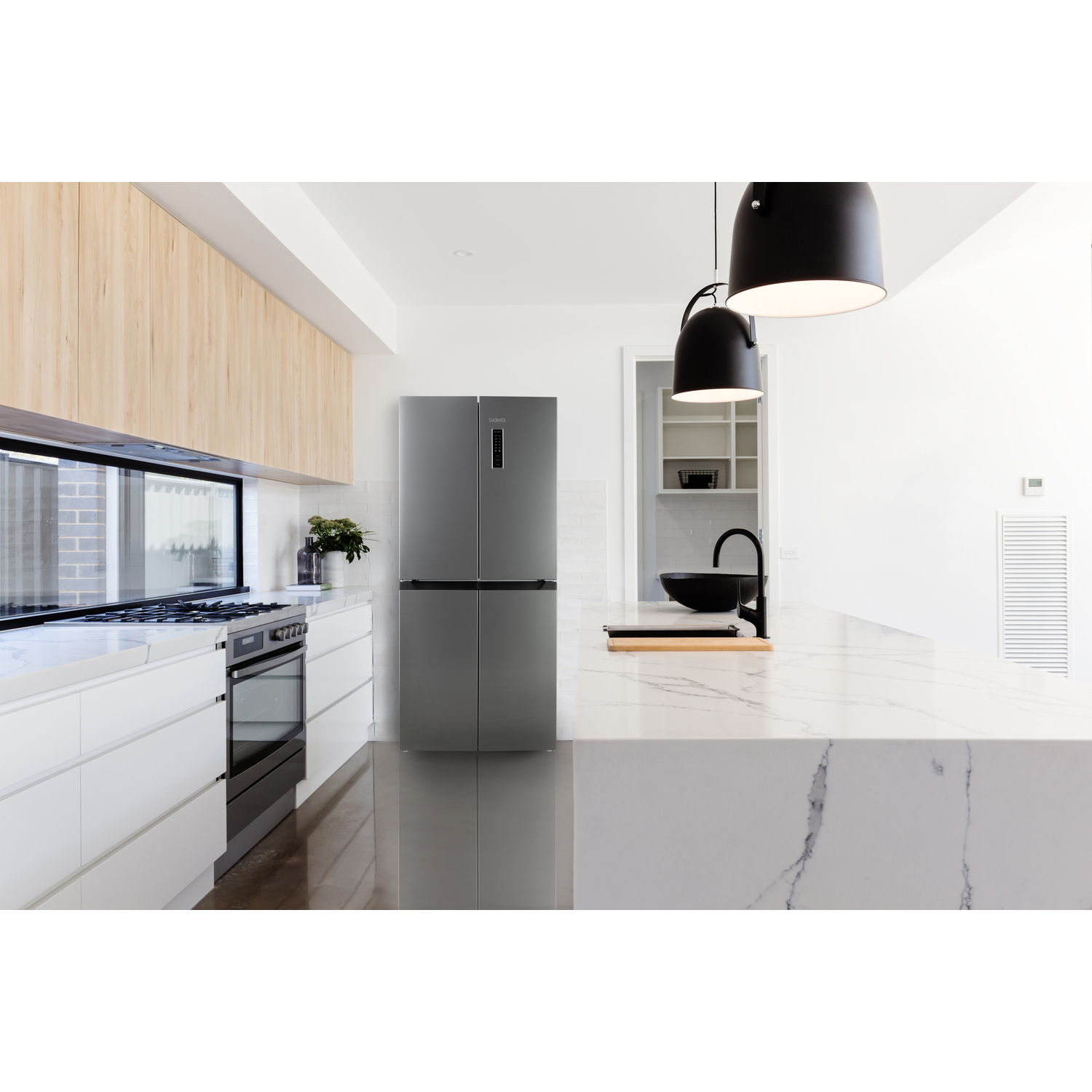 Modern kitchen with a refrigerator, countertop, and pendant lights. Clean and spacious.