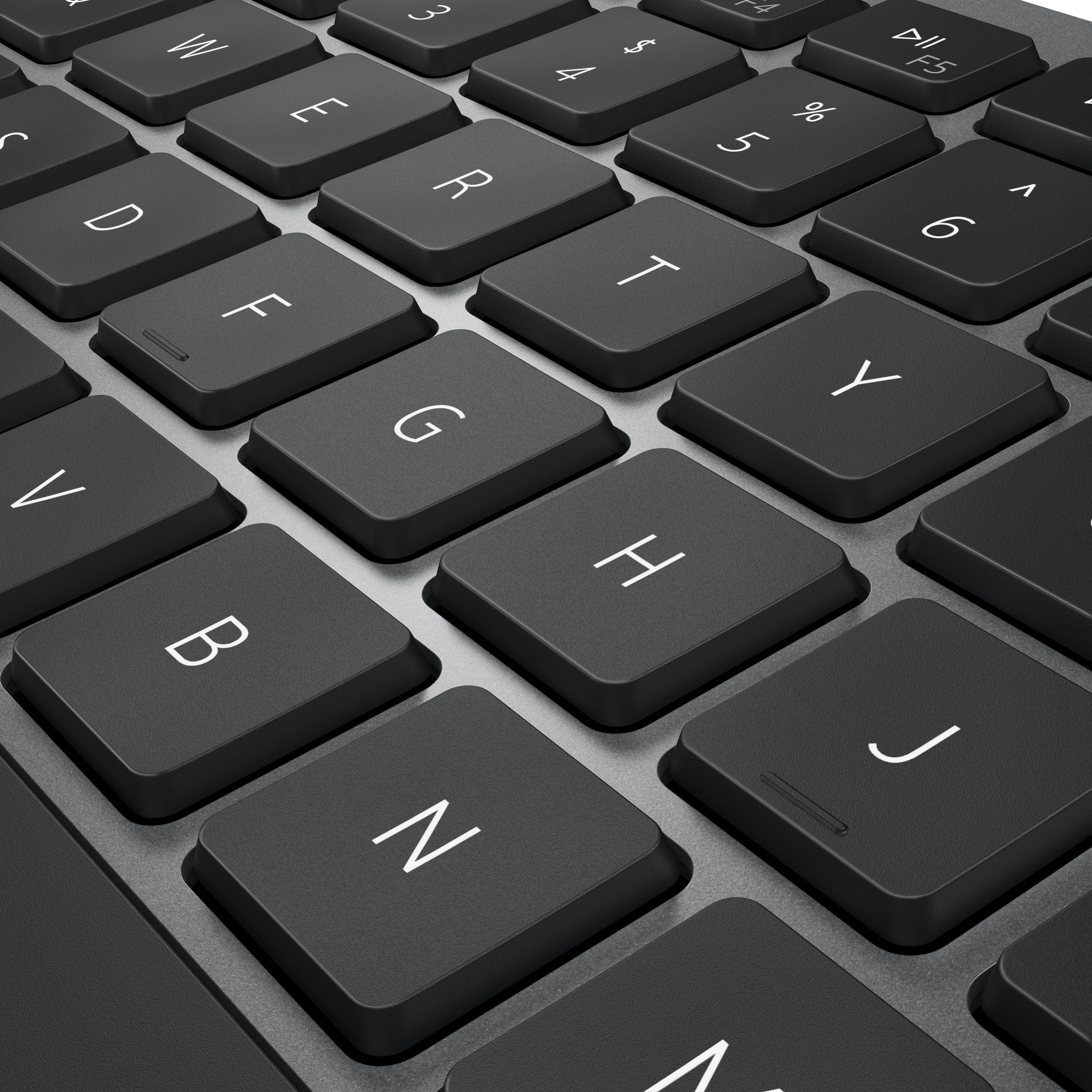 Primer plano de teclas de teclado negras. Letras G, H, N y otras visibles.