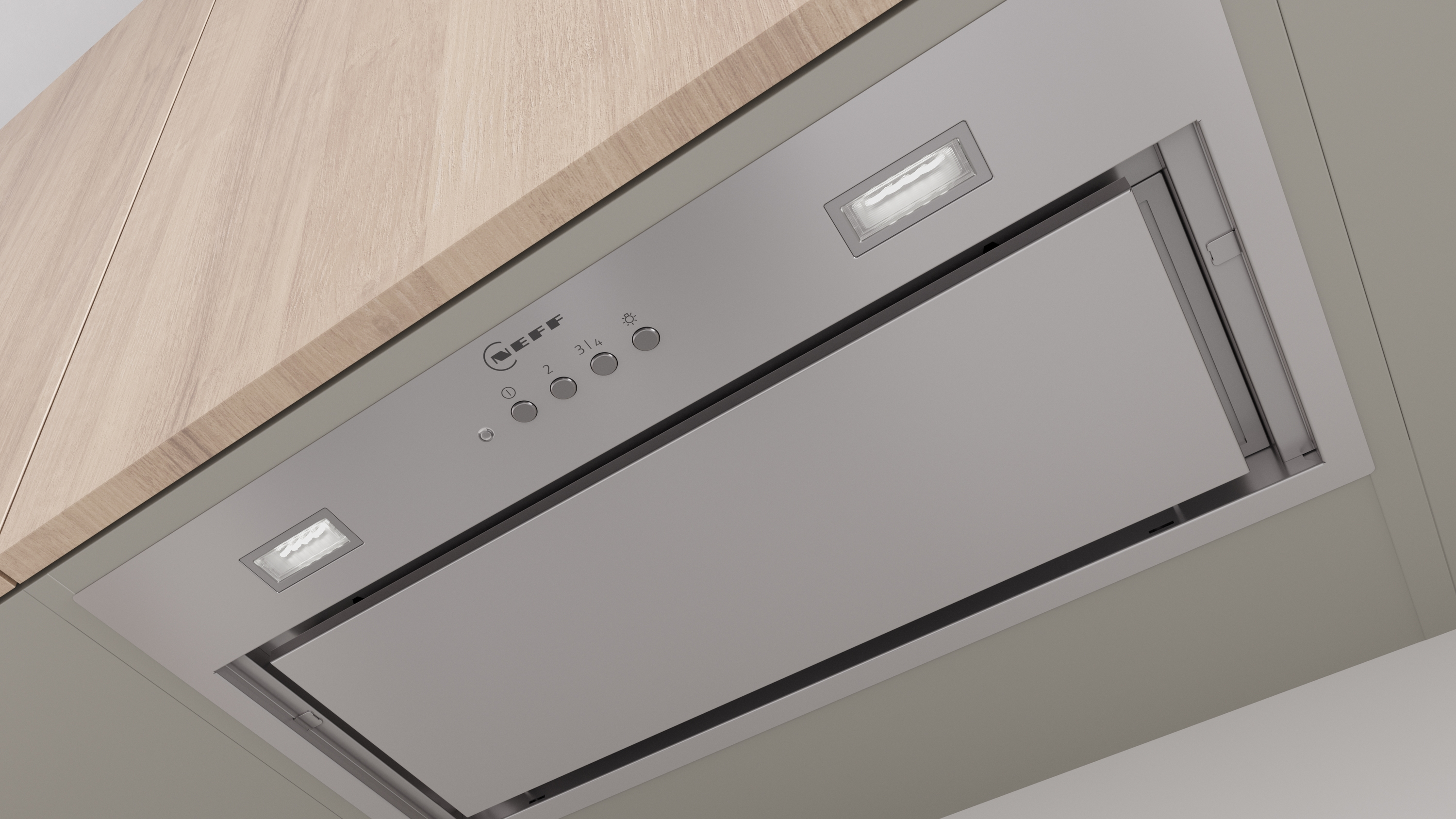 Unteransicht einer Edelstahl-Dunstabzugshaube mit Lichtern, unter einem Schrank montiert.
