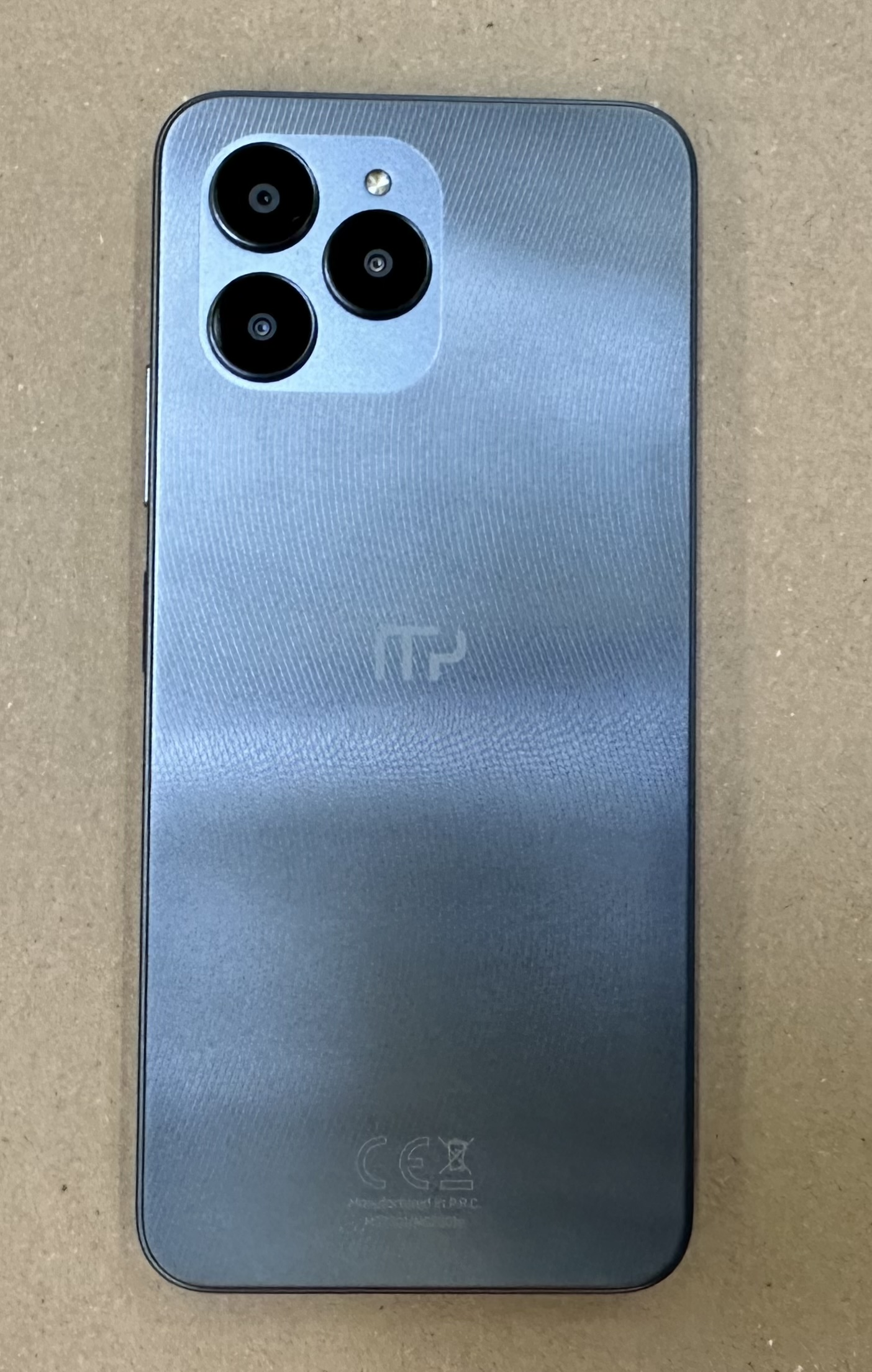 Tył telefonu z trzema aparatami. Ma szary gradient i logo marki.