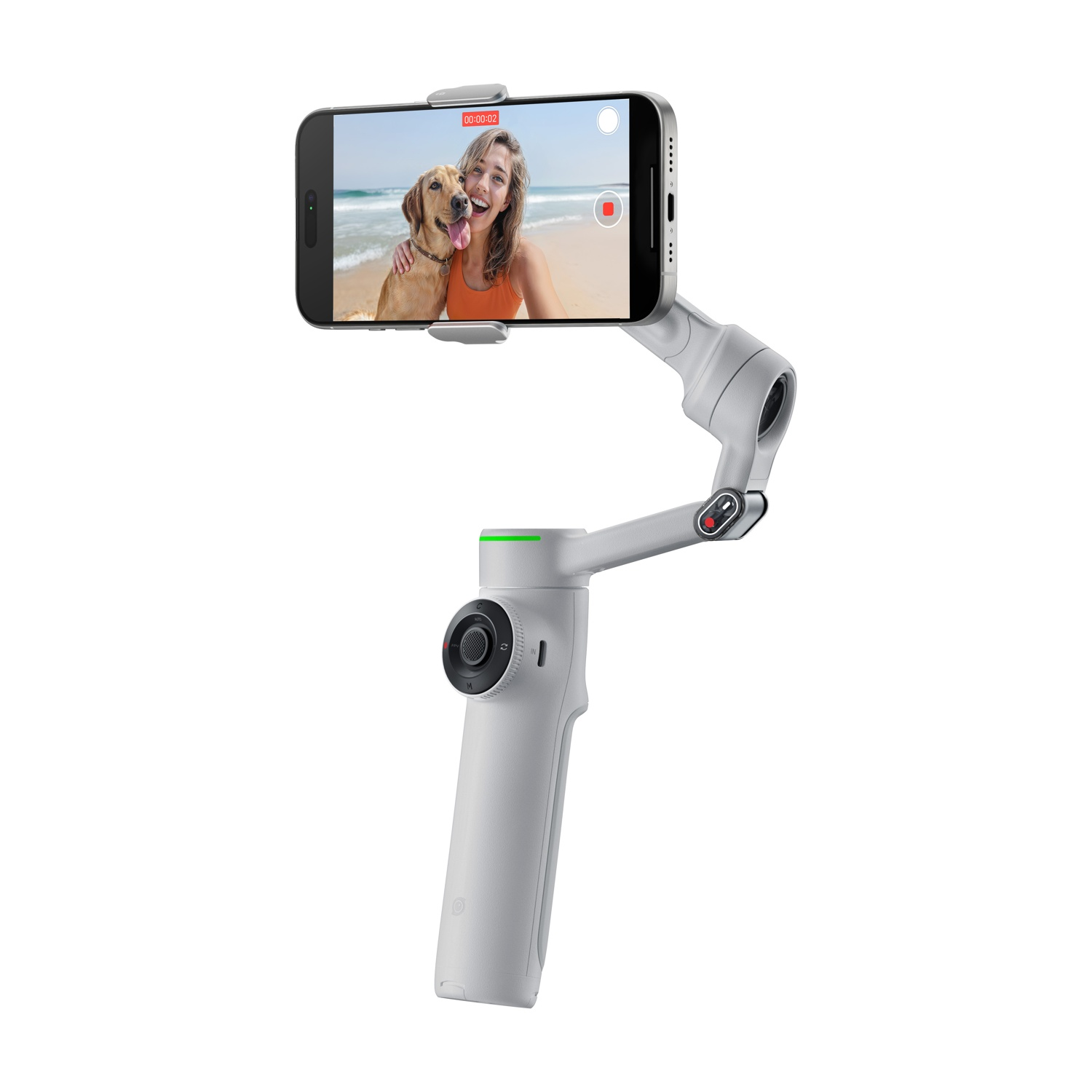 Uno stabilizzatore gimbal bianco che tiene un telefono con una donna e un cane su una spiaggia.