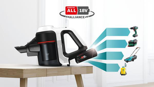 Staubsauger mit Akku und anderen Werkzeugen auf einem Tisch. Power für alle 18V Allianz Logo.