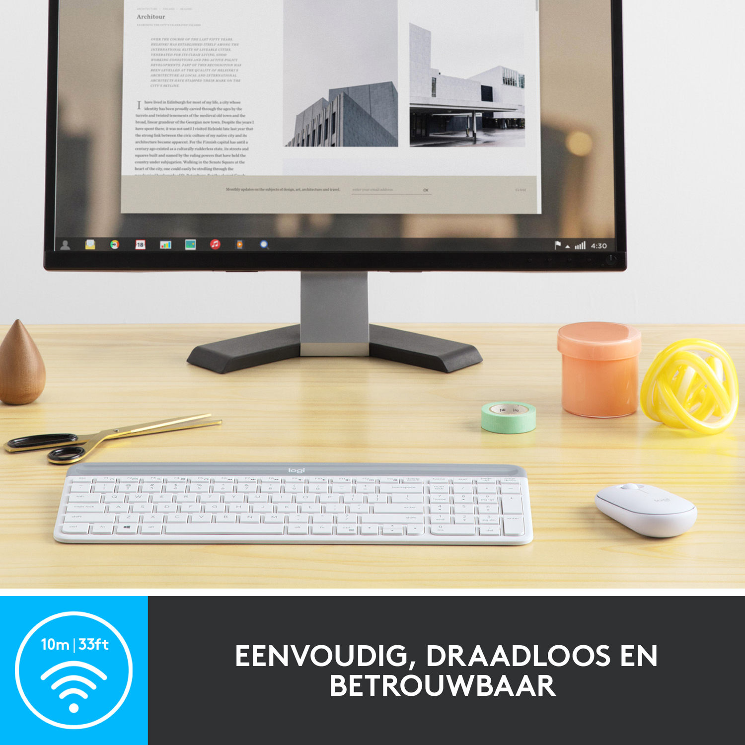 A white keyboard and mouse in front of a computer monitor. There are decorative items on the table.