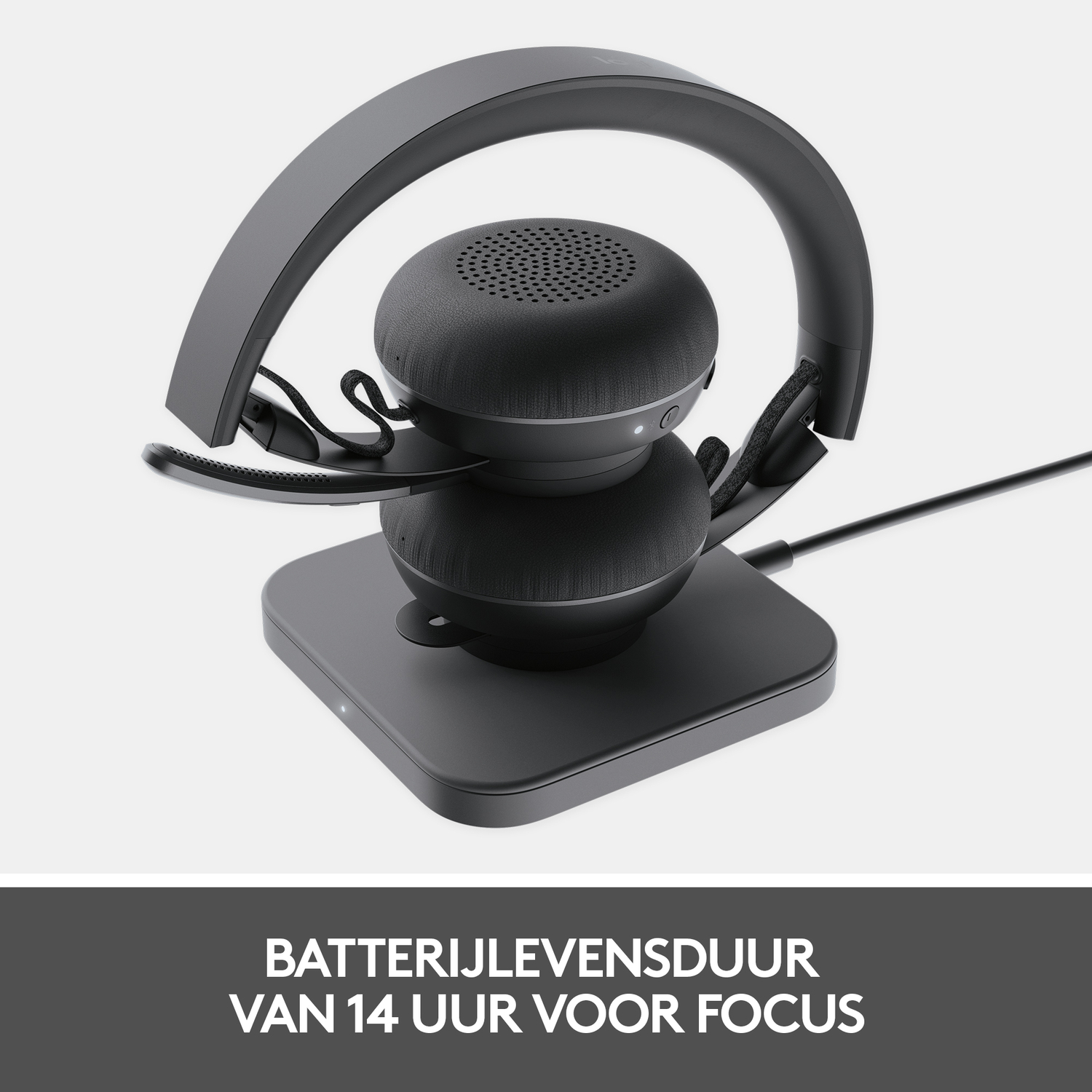 Black headset on a charging base. Text about battery life.