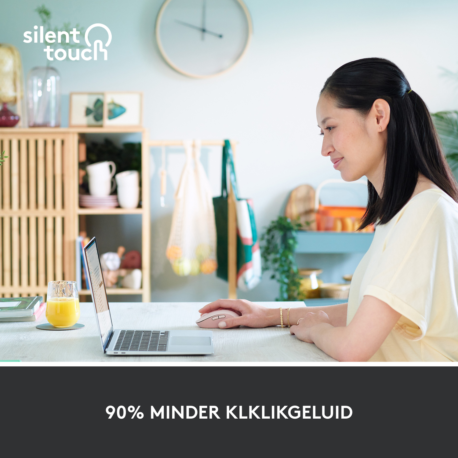 A woman is using a laptop with a mouse on a table in a room.
