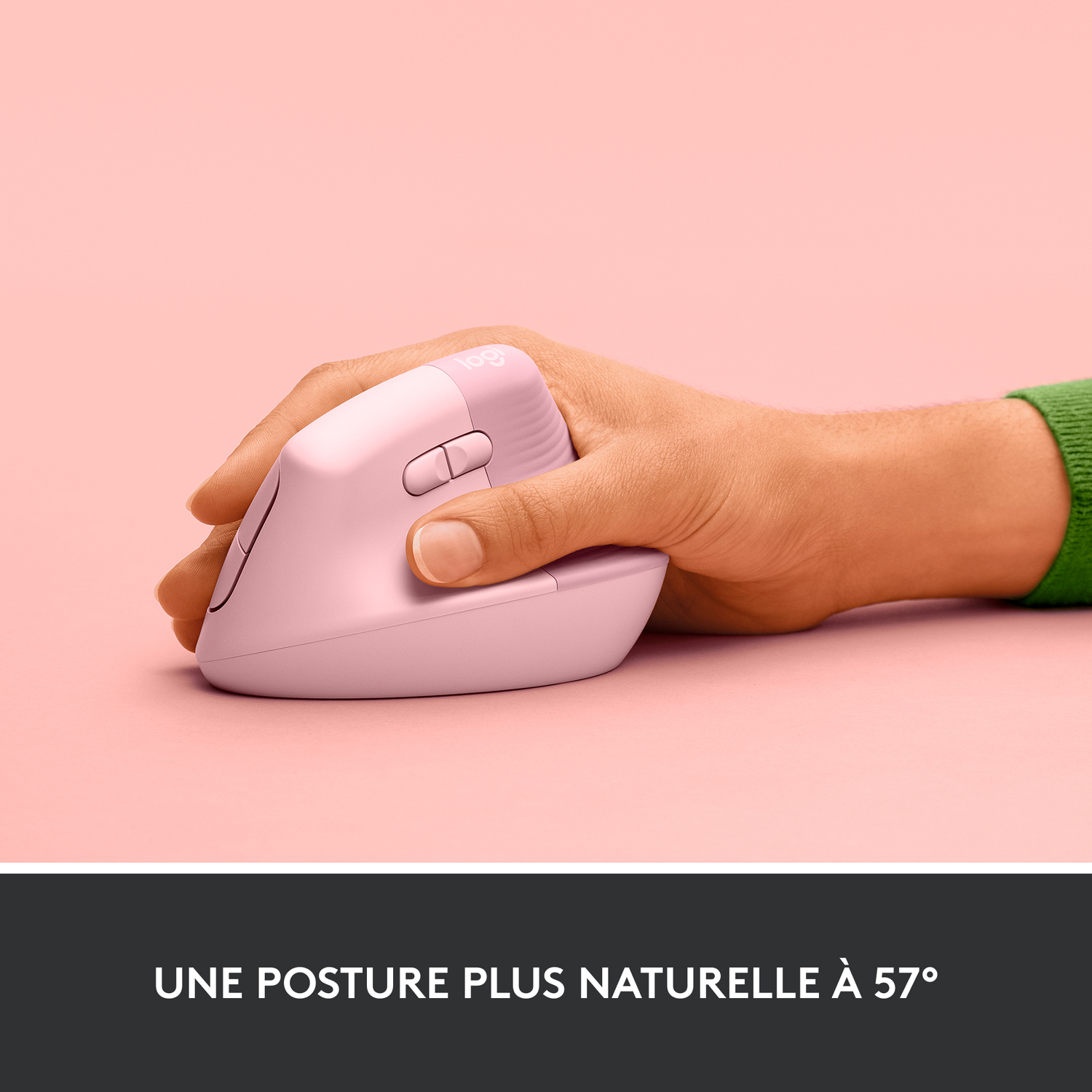 Main tenant une souris verticale rose sur fond rose, pour une posture naturelle.