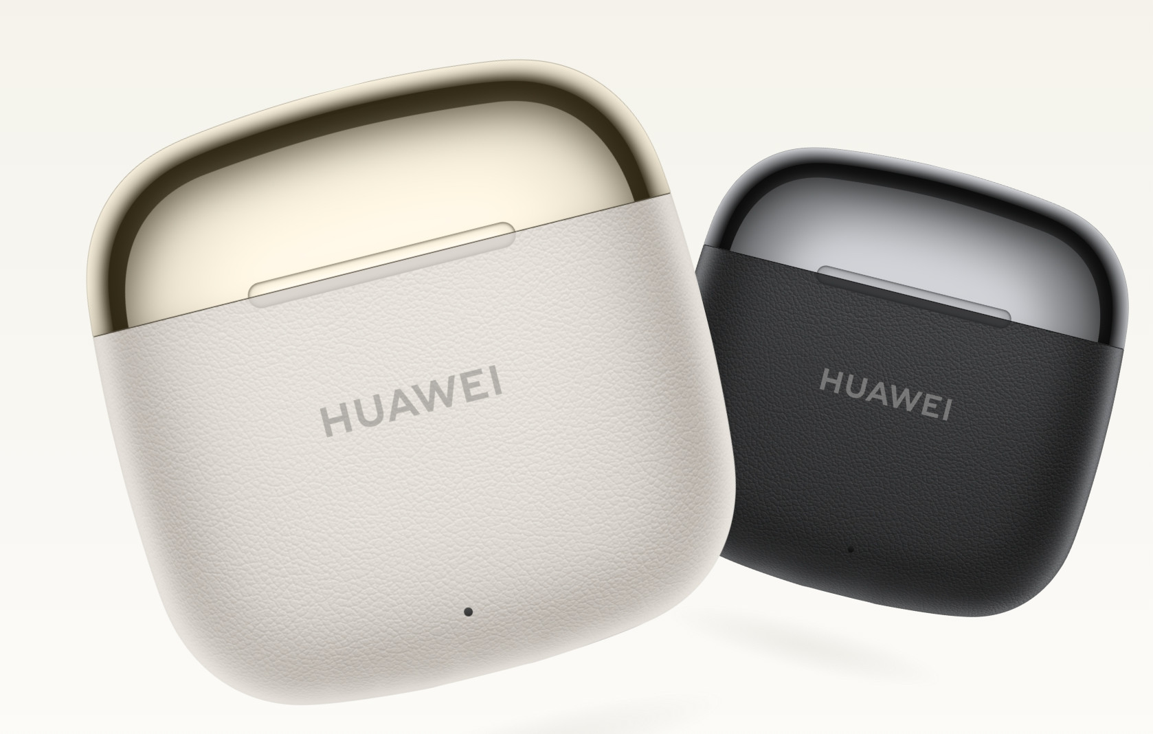 Dwa etui na słuchawki, białe i czarne, z logo Huawei. Białe etui ma złote obramowanie.