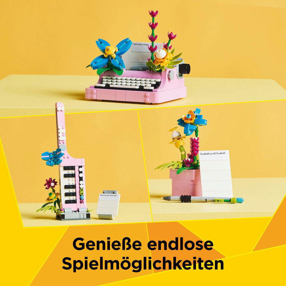 LEGO-Modelle mit Blumen, einer rosa Schreibmaschine und einem Notizblock mit Stift.