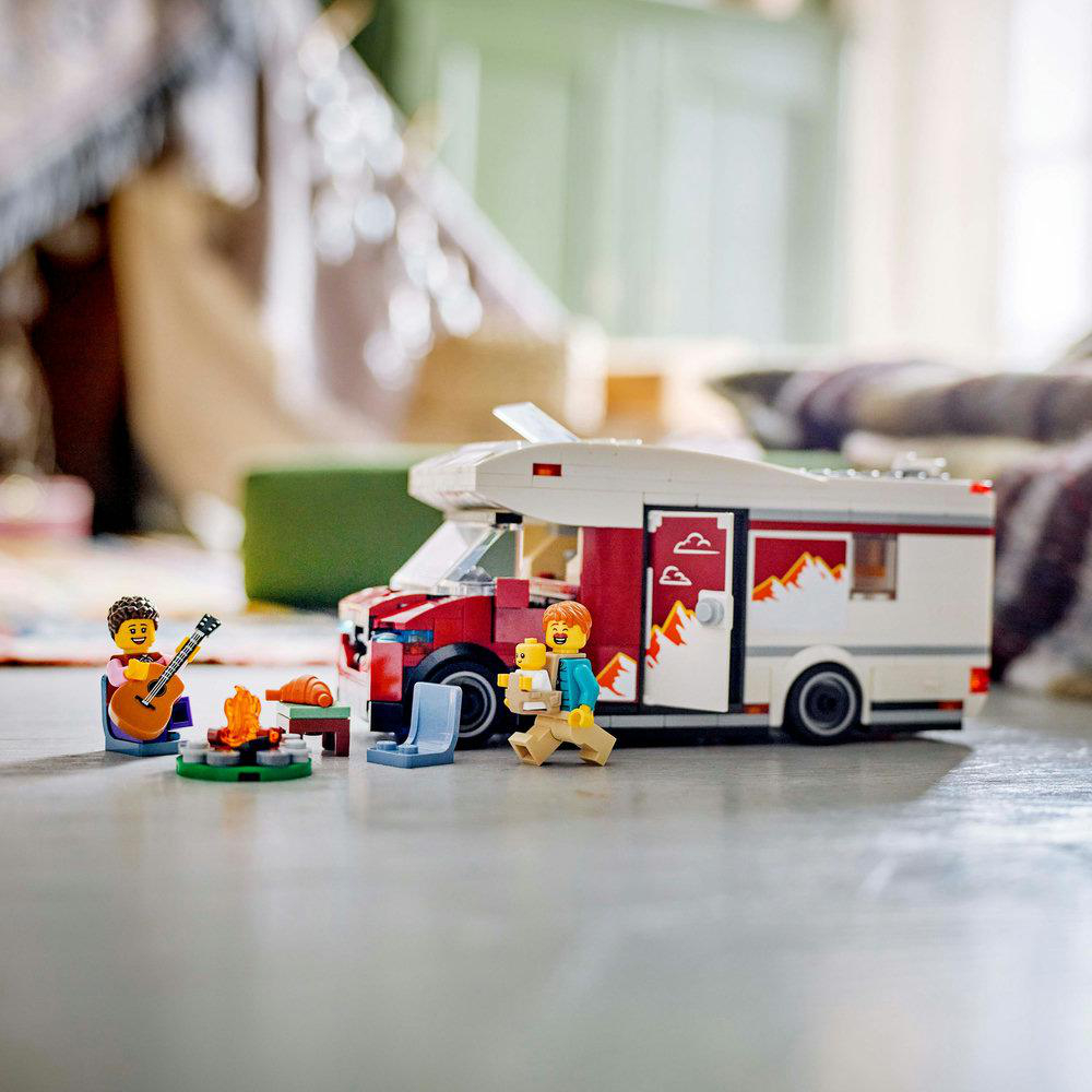 Lego-Wohnwagen-Szene mit Figuren um ein Lagerfeuer.