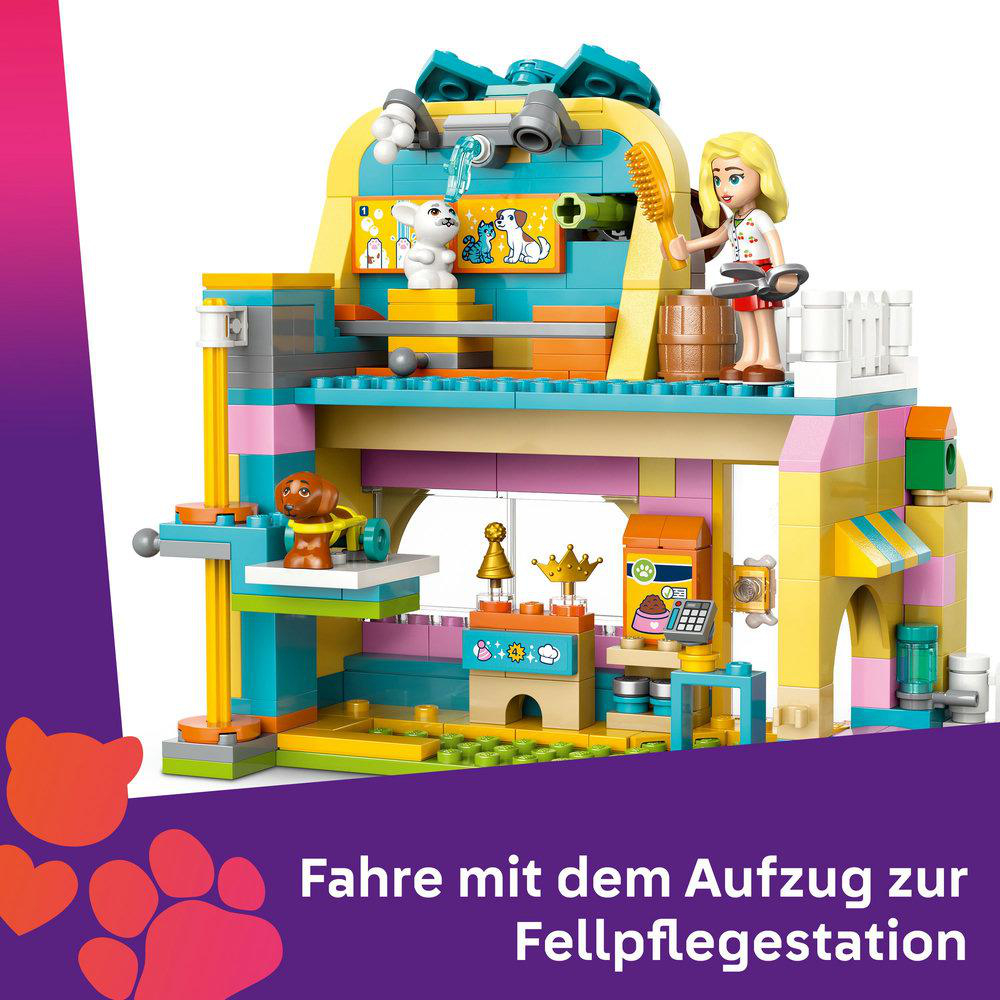 Farbenfrohes Spielzeugset eines Tierpflege-Salons mit einer Frau.