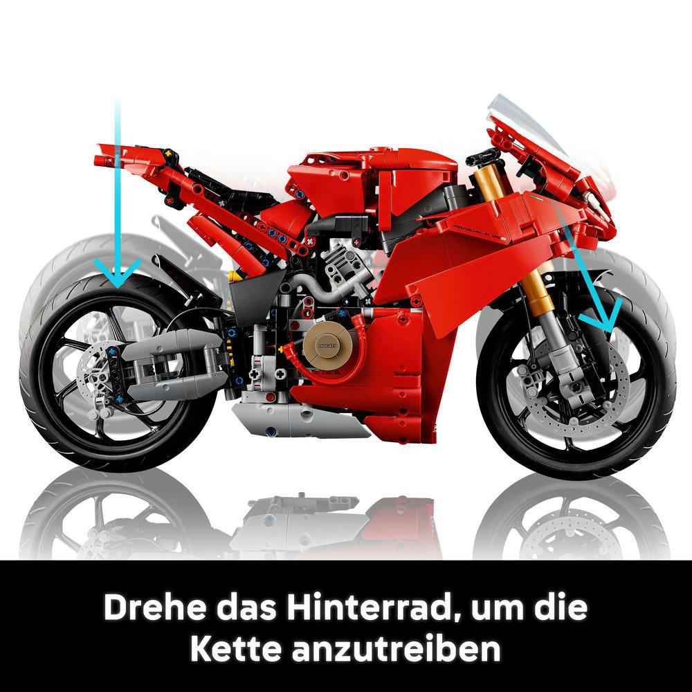 Rotes Spielzeugmotorrad mit schwarzen Rädern und blauen Pfeilen, Seitenansicht.