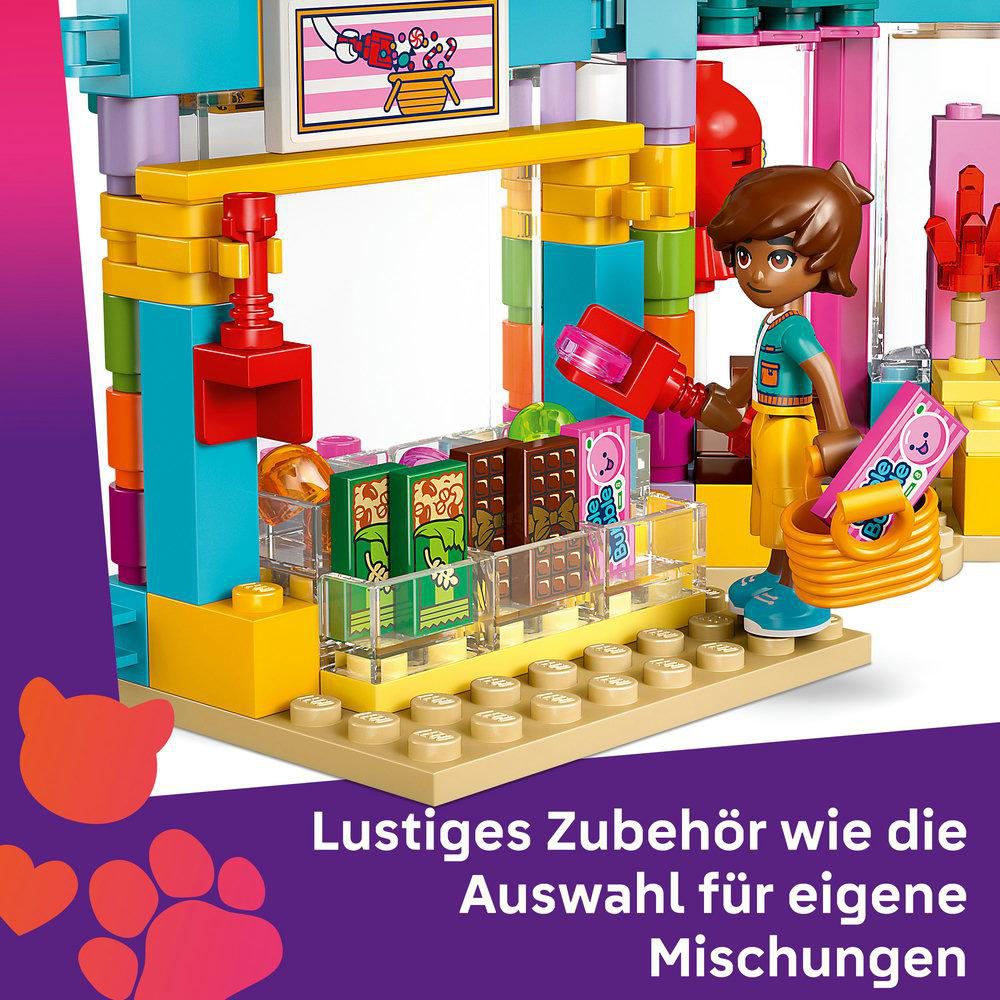 Ein LEGO-Set mit einer Figur, die einen Korb und ein rotes Gerät in einem Spielzeugladen hält.