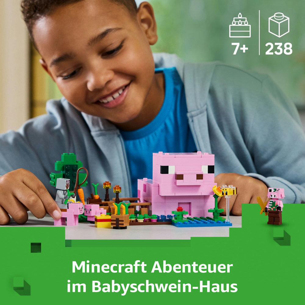 Kind spielt mit Lego Minecraft Set. Rosa Schweinehaus, Figuren und grüne Basis.