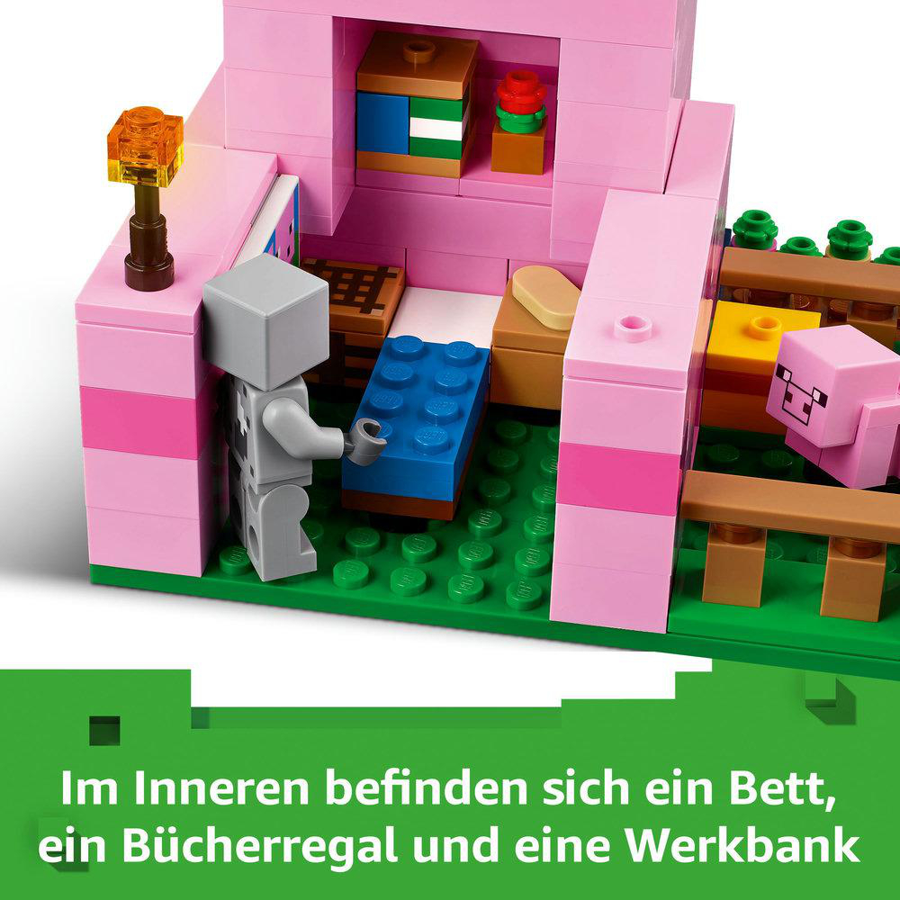 Minecraft Lego-Set eines rosa Hausinneren mit Bett, Bücherregal und Werkbank.