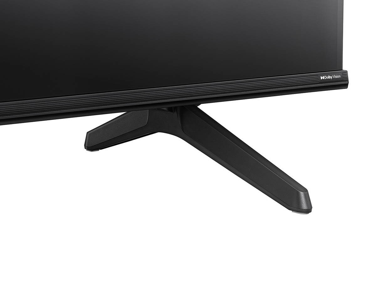 Widok od dołu czarnego telewizora, pokazujący podstawę i logo Dolby Vision.
