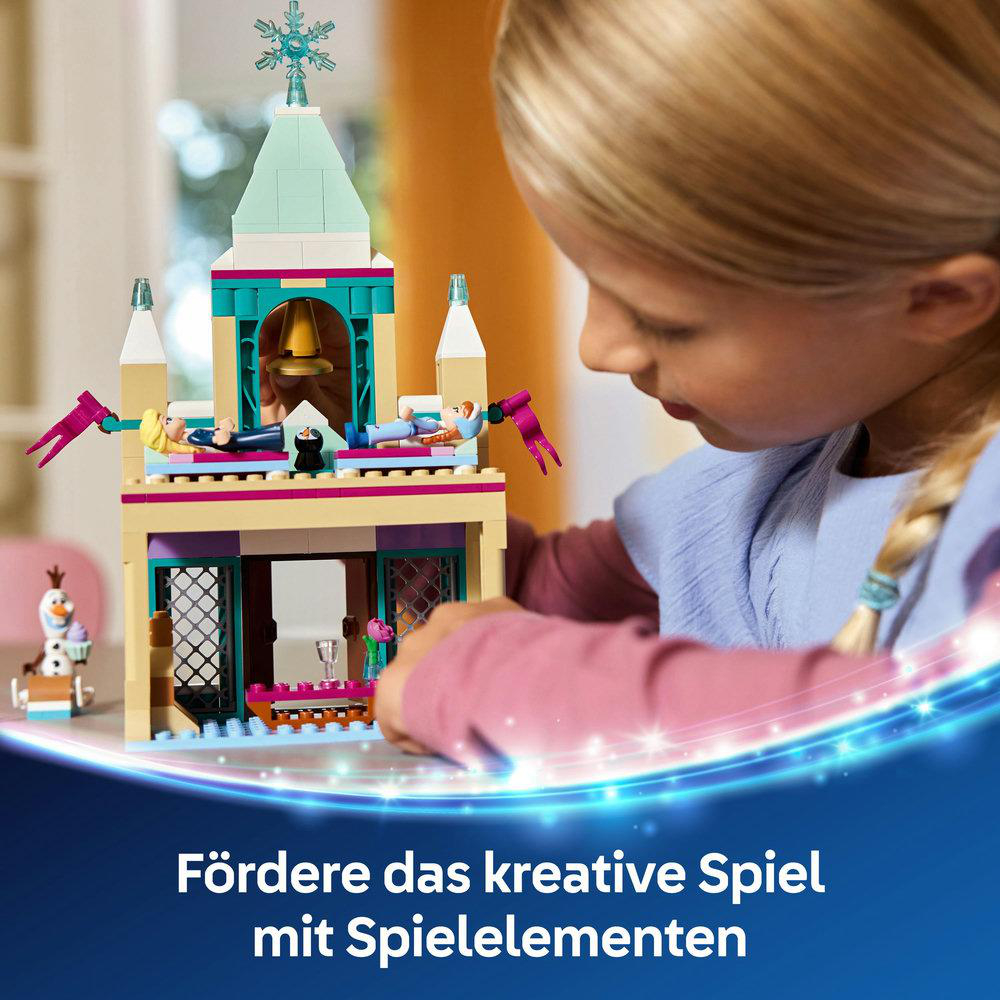 Ein junges Mädchen baut ein LEGO Frozen-Schloss, wobei der Fokus auf dem Spielset mit Text liegt.