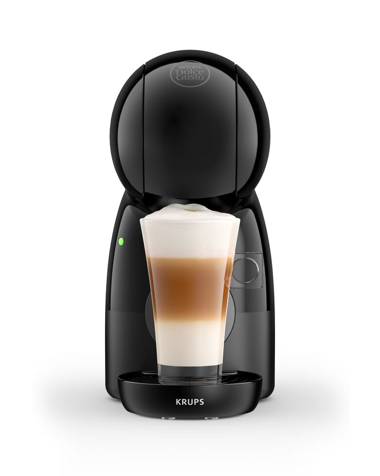 Een zwarte Krups koffiemachine maakt latte met wit schuim.