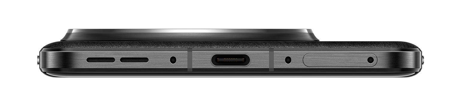 Widok od dołu czarnego telefonu. Port USB-C, głośnik i mikrofon. Czarne tło.