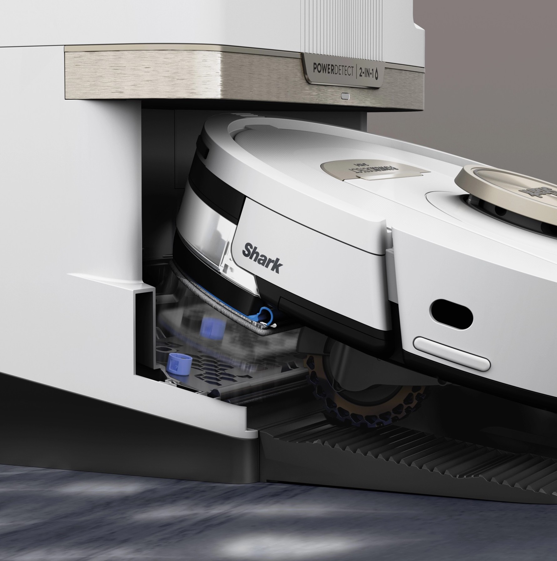 Un aspirateur robot blanc et gris à l'intérieur d'une station de charge.