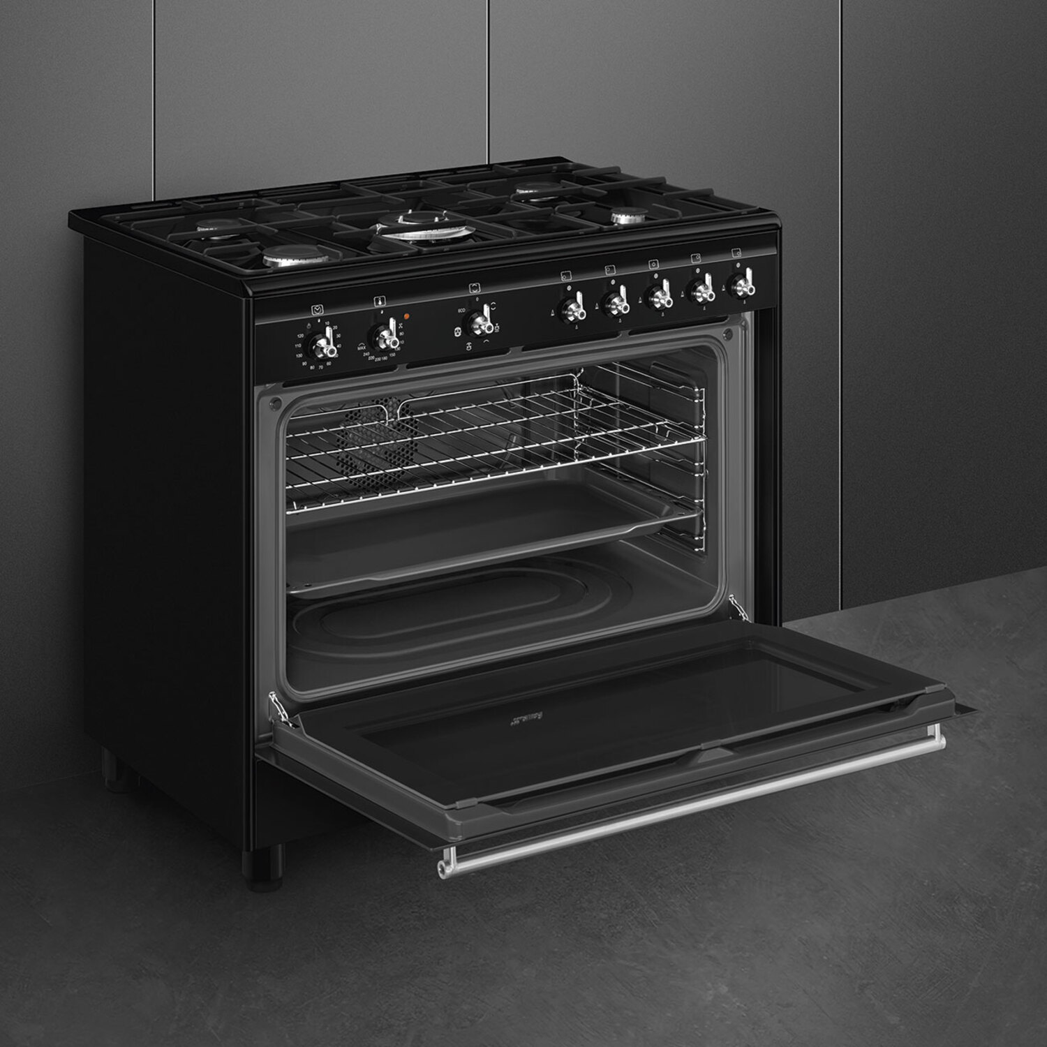 A black Smeg oven with the door open. It has multiple burners and control knobs on top.