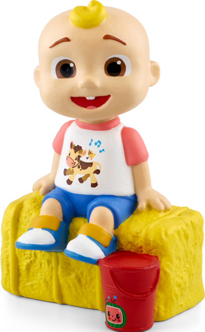 Eine Figur eines Cartoon-Babys sitzt auf Heu. Das Baby trägt ein Hemd, blaue Shorts und Schuhe. Daneben steht ein roter Eimer.