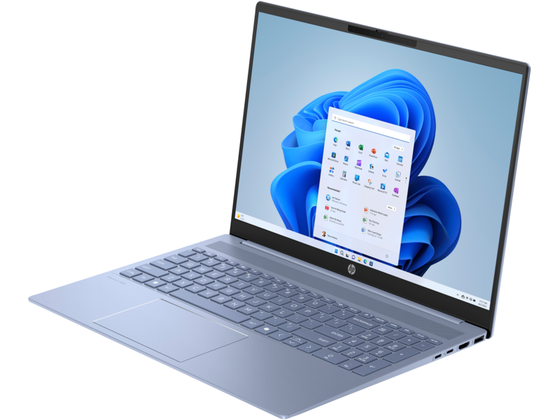 Kék laptop nyitva az asztalon, Windows 11 asztalt mutat.