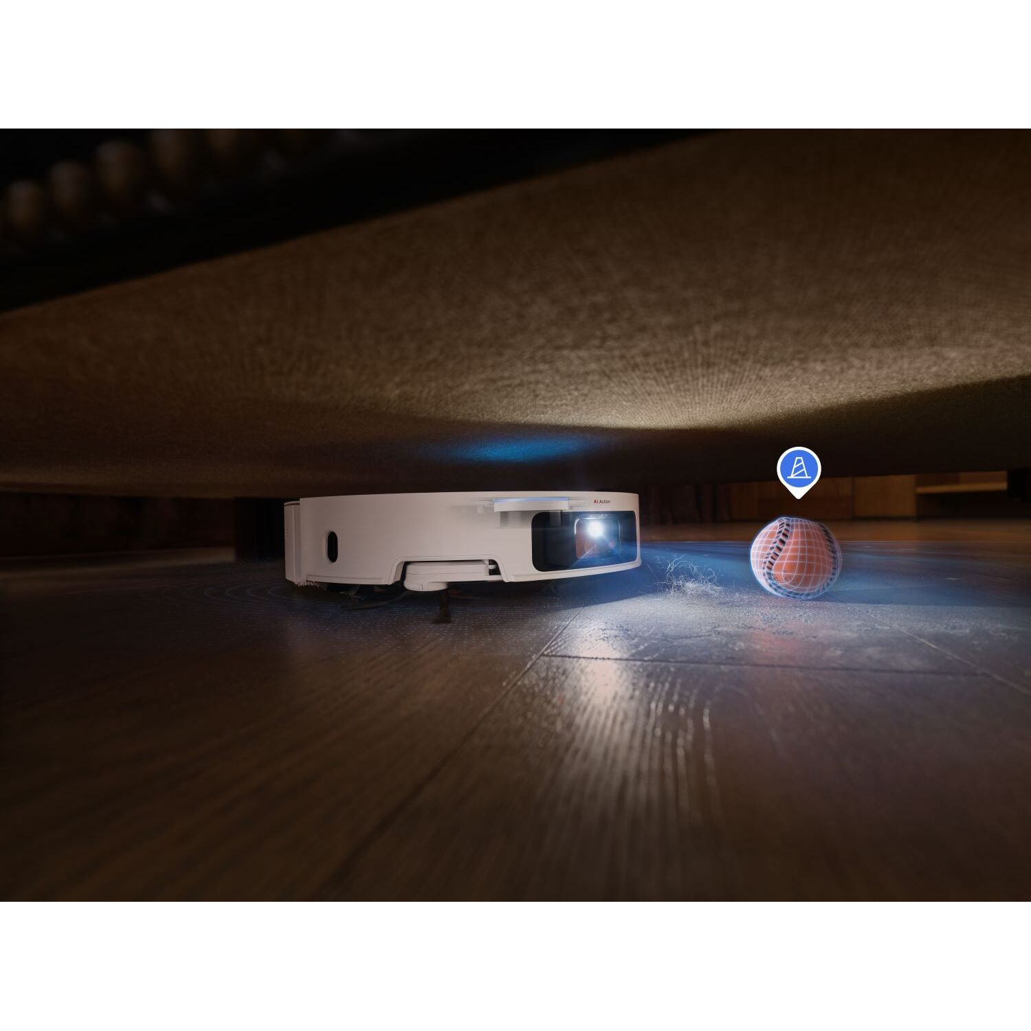 Robot vacuum cleaner under a sofa. A ball is highlighted.