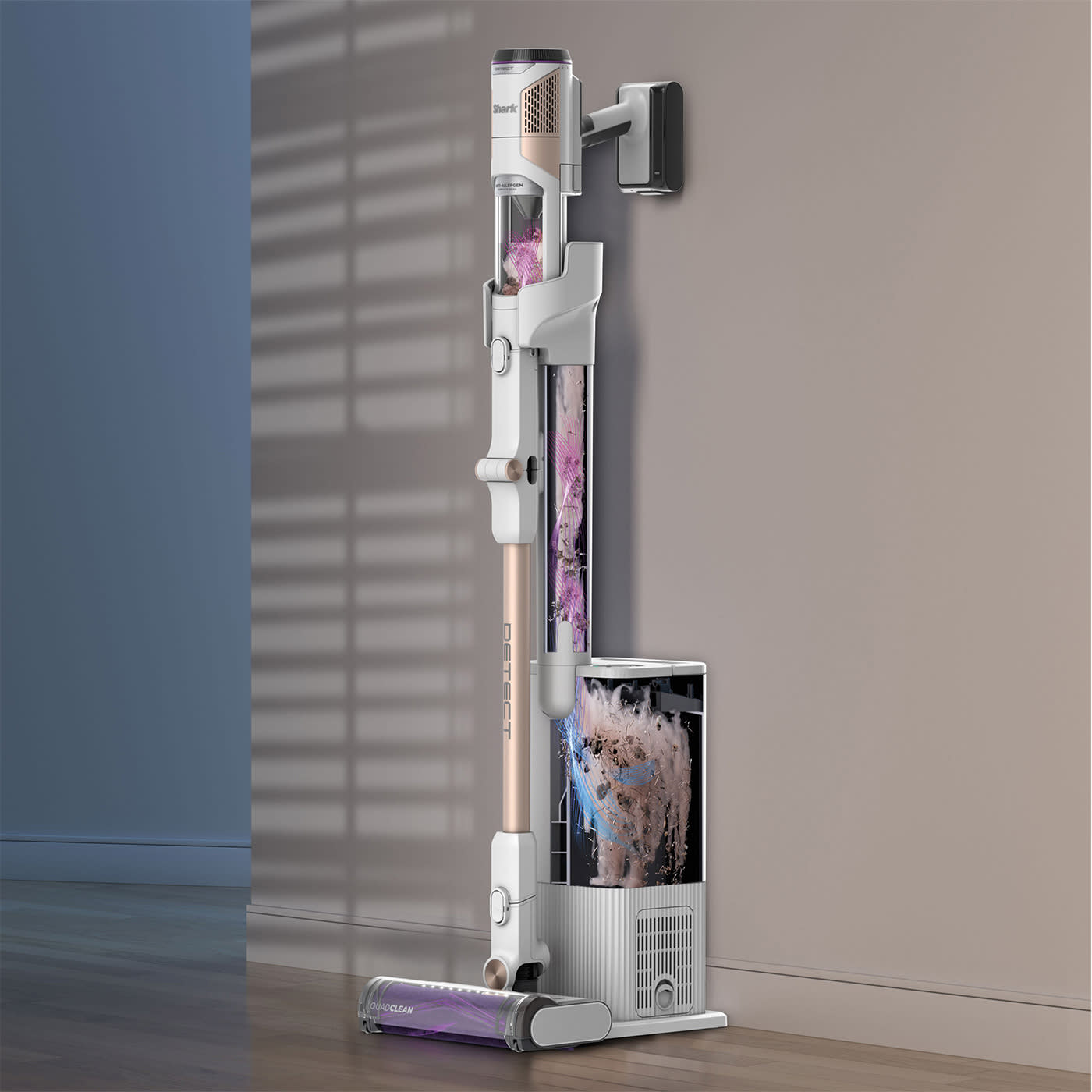 Aspirapolvere verticale su un muro grigio. Accenti oro rosa e viola.