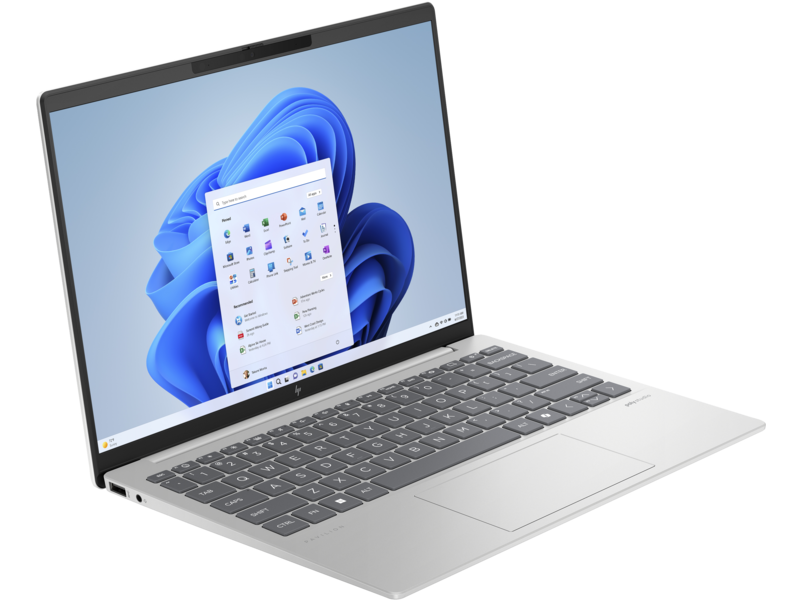 Ezüst laptop Windows 11 képernyővel, ikonokat és kék hátteret mutat.