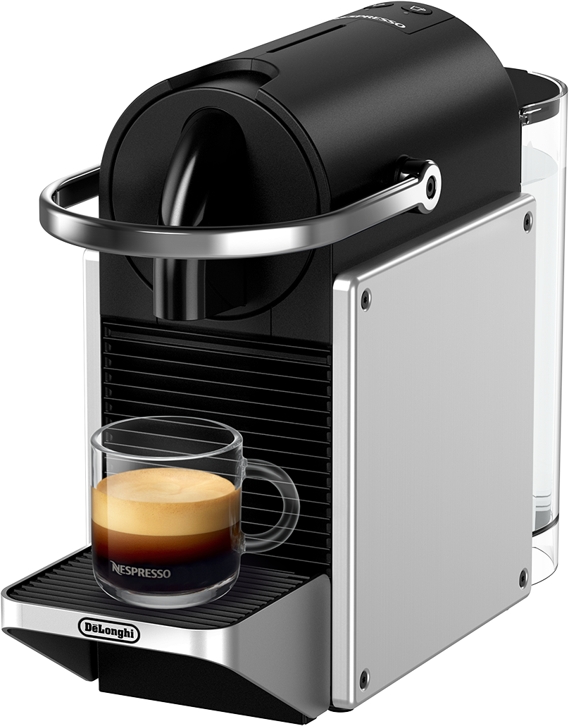 Ezüst és fekete Nespresso kávéfőző egy üveg kávéscsészével egy fekete tálcán.