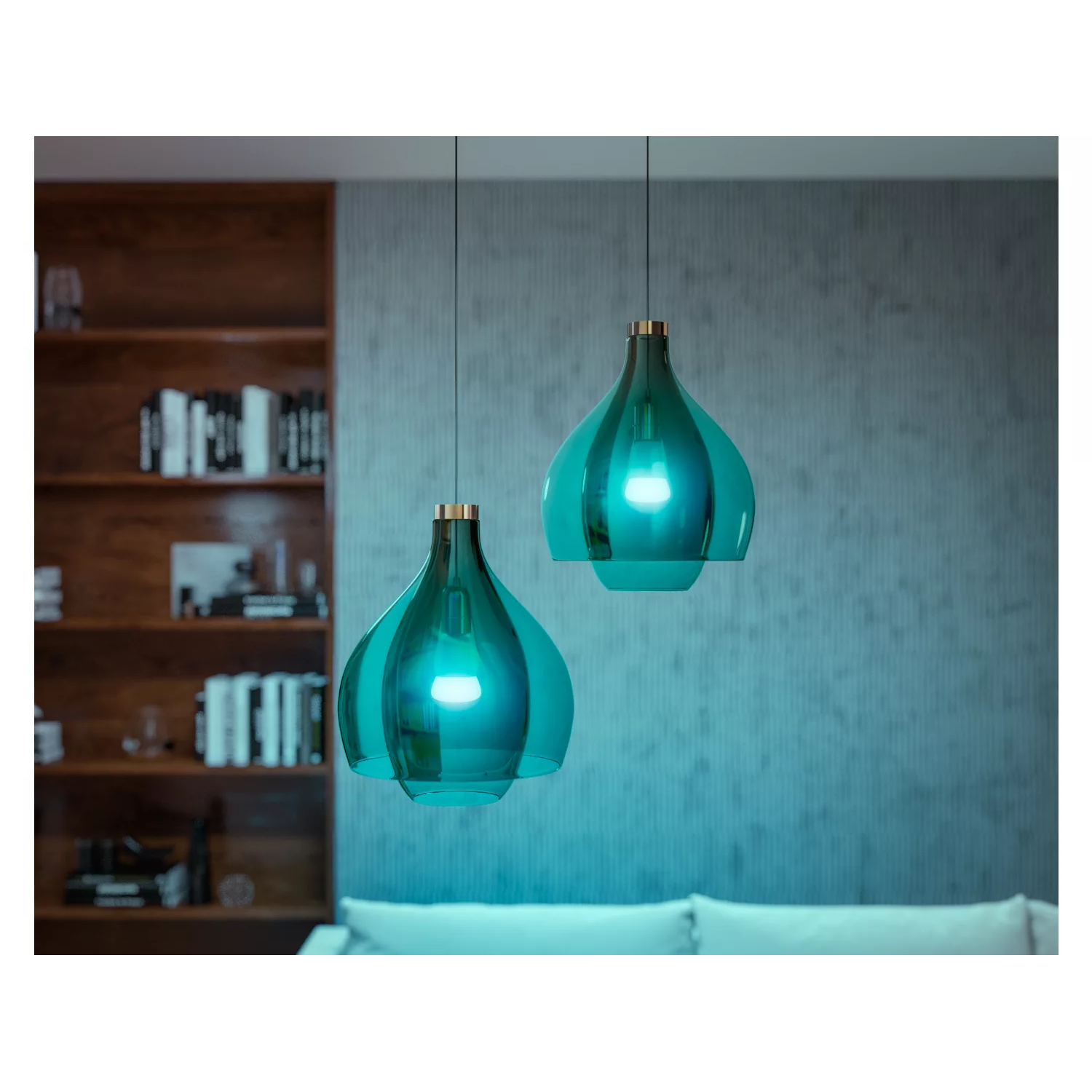 Two teal-colored hanging pendant lights over a bookshelf.