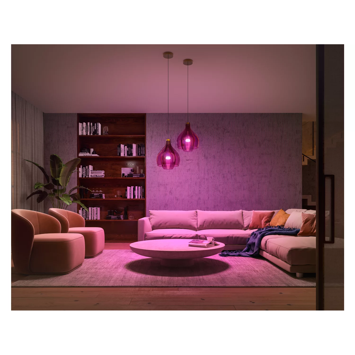 Living room lit with pink light. Sofa, chairs, bookshelf, and pendant lights are visible.