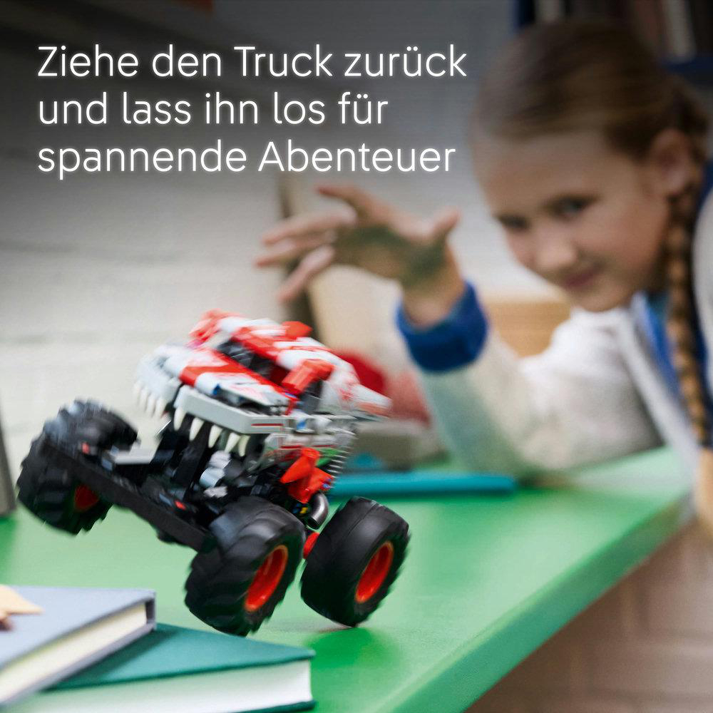 Kind, das nach einem Spielzeug-LKW greift. Text: Ziehe den Truck zurück und lass ihn los.