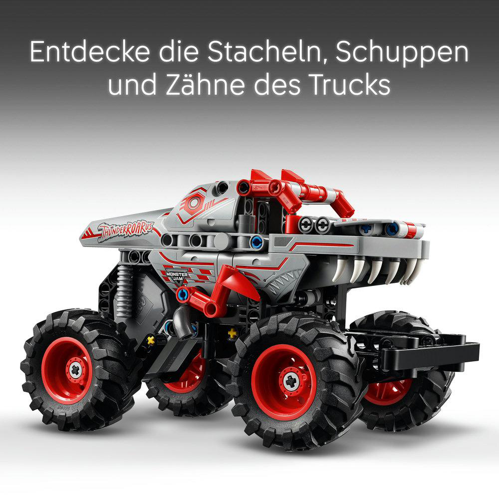 Spielzeug-Monstertruck, grau mit roten Akzenten, große Räder.