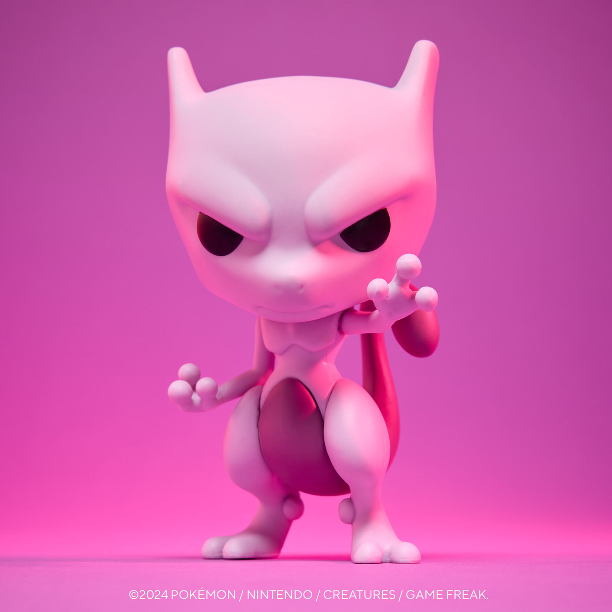 Una figura bianca di Mewtwo con accenti rosa, in piedi su uno sfondo sfumato rosa.