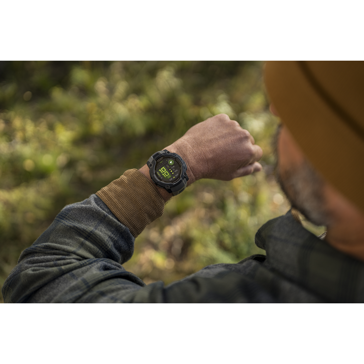 Man looking at a smartwatch on his wrist.