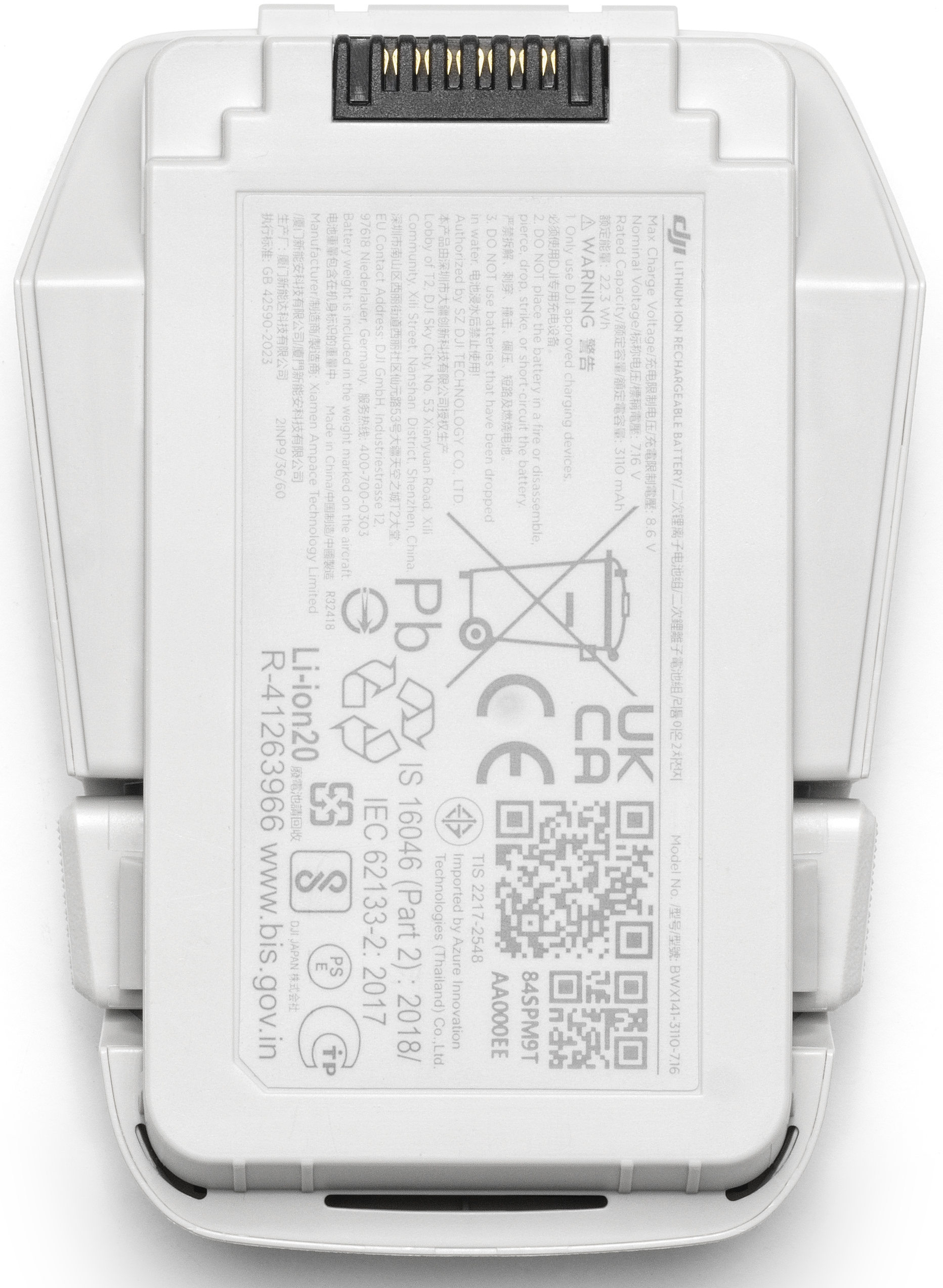 Batterie de drone blanche avec diverses étiquettes, ports et un avertissement. Texte visible.
