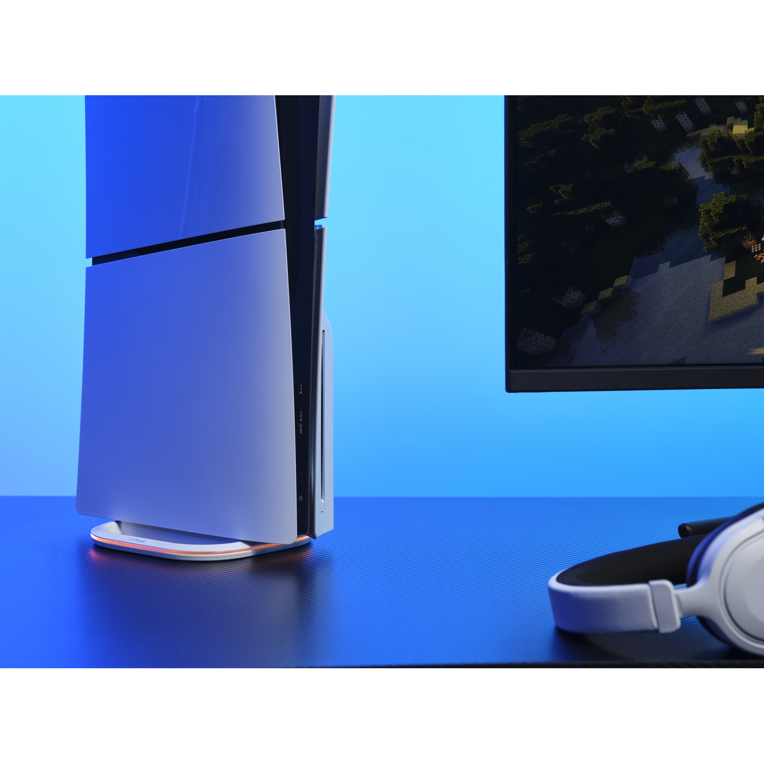 A video game console stands on a table with other items.