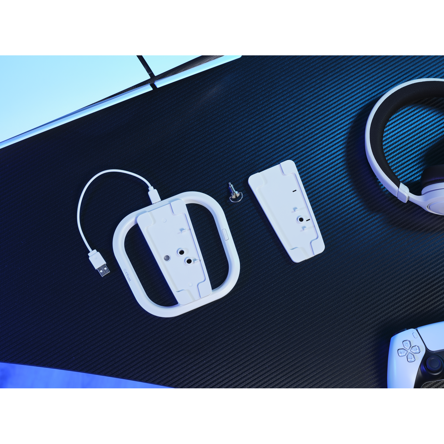 Gaming setup with controller, headphones, and charger.