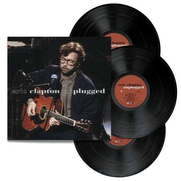 Eric Clapton Unplugged Albumcover und drei Vinylplatten, schwarz mit Etiketten.
