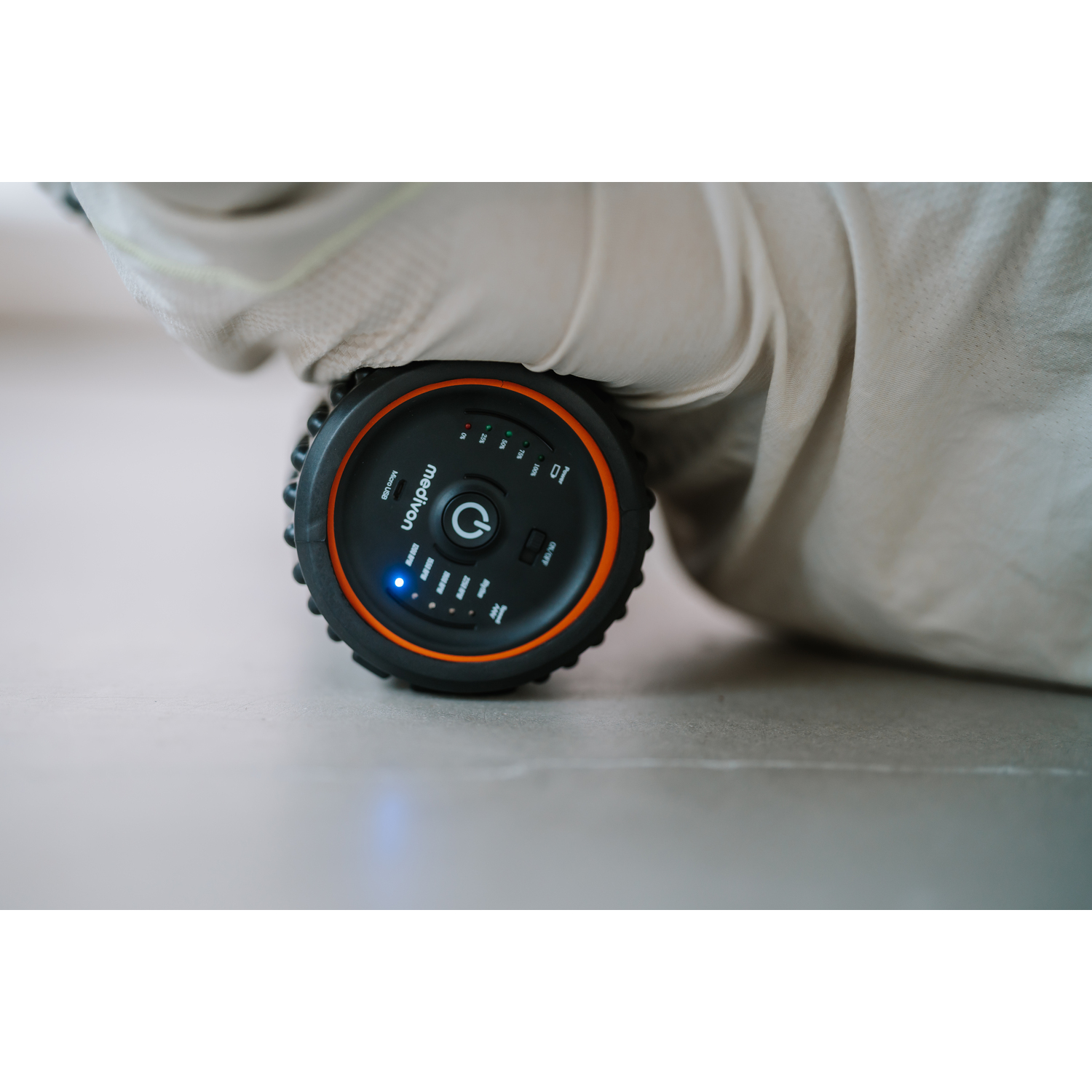Close up of the roller. Black and orange colors, some buttons.